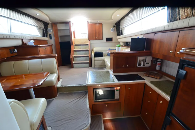 Slide: The Image of Luxurious interior of 2001 Cruisers Yachts 3750 Motoryacht with modern kitchen and seating area. - 24