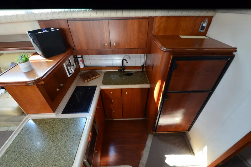 Slide: The Image of 2001 Cruisers Yachts 3750 Motoryacht kitchen with wood cabinetry and modern appliances. - 25