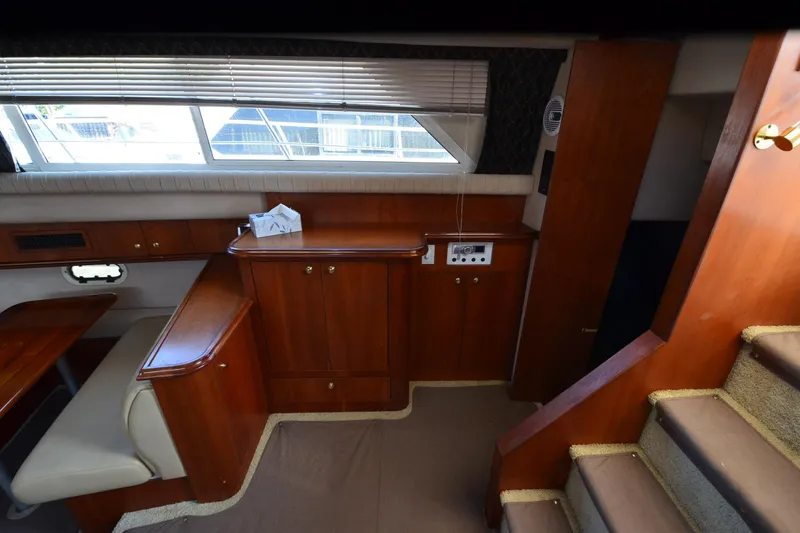 Slide: The Image of 2001 Cruisers Yachts 3750 Motoryacht interior with wooden cabinetry and seating area. - 31