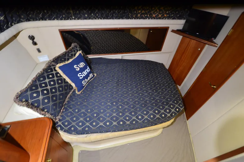 Slide: The Image of Luxurious bedroom in 2001 Cruisers Yachts 3750 Motoryacht with nautical-themed bedding. - 32