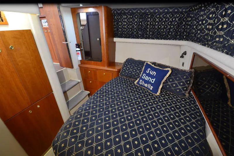 Slide: The Image of Luxurious 2001 Cruisers Yachts 3750 Motoryacht cabin with nautical-themed bedding. - 33
