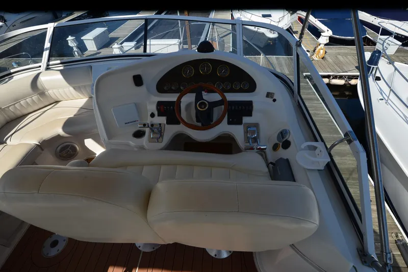 Slide: The Image of 2001 Cruisers Yachts 3750 Motoryacht helm with leather seats and wooden steering wheel. - 38