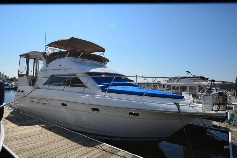 Slide: The Image of 2001 Cruisers Yachts 3750 Motoryacht docked at marina under clear blue sky. - 45