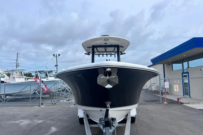 Slide: The Image of 2023 Sea Hunt Ultra 265 SE boat on trailer, displayed outdoors. - 1