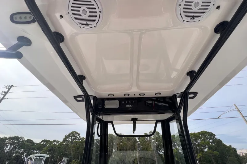 Slide: The Image of 2023 Sea Hunt Ultra 265 SE boat interior roof with speakers and lighting. - 15