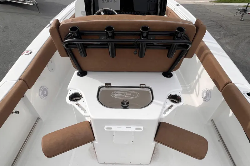 Slide: The Image of 2023 Sea Hunt Ultra 265 SE boat interior with seating and rod holders. - 16