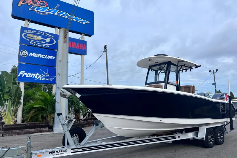 Slide: The Image of 2023 Sea Hunt Ultra 265 SE boat on trailer at Pro Marine dealership. - 2