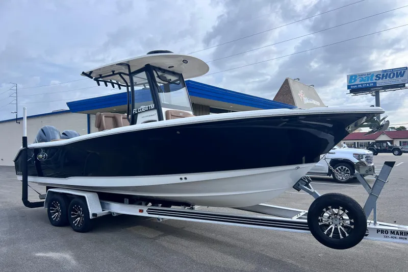 Slide: The Image of 2023 Sea Hunt Ultra 265 SE boat on trailer, displayed outdoors. - 3