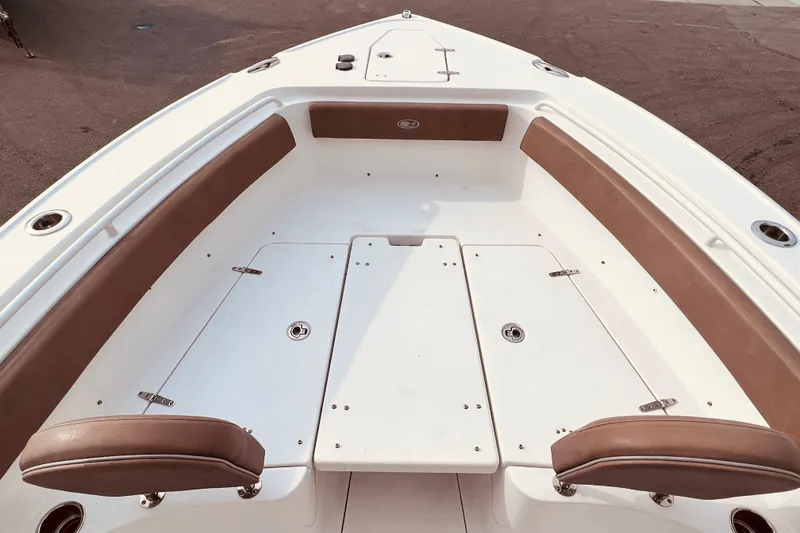 Slide: The Image of 2023 Sea Hunt Ultra 265 SE boat interior with cushioned seating and storage compartments. - 9
