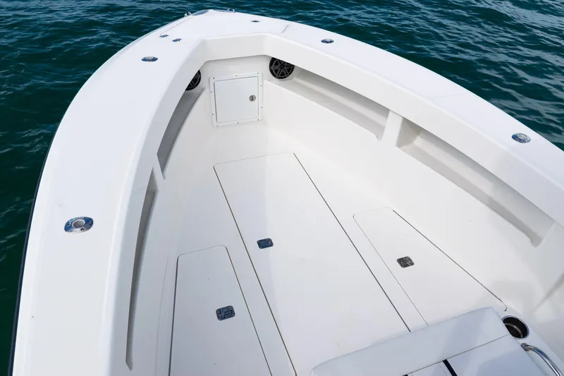 Slide: The Image of 2018 SeaVee 29 boat deck with storage compartments, floating on blue water. - 12