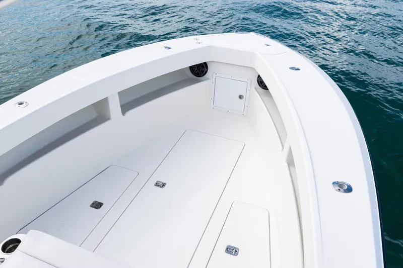 Slide: The Image of 2018 SeaVee 29 boat deck with storage compartments, floating on calm water. - 14