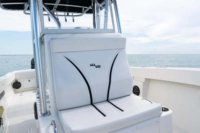 Slide: The Image of 2018 SeaVee 29 boat interior with cushioned seating and ocean view. - 15