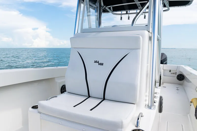 Slide: The Image of 2018 SeaVee 29 boat interior with white seating, ocean view in background. - 17