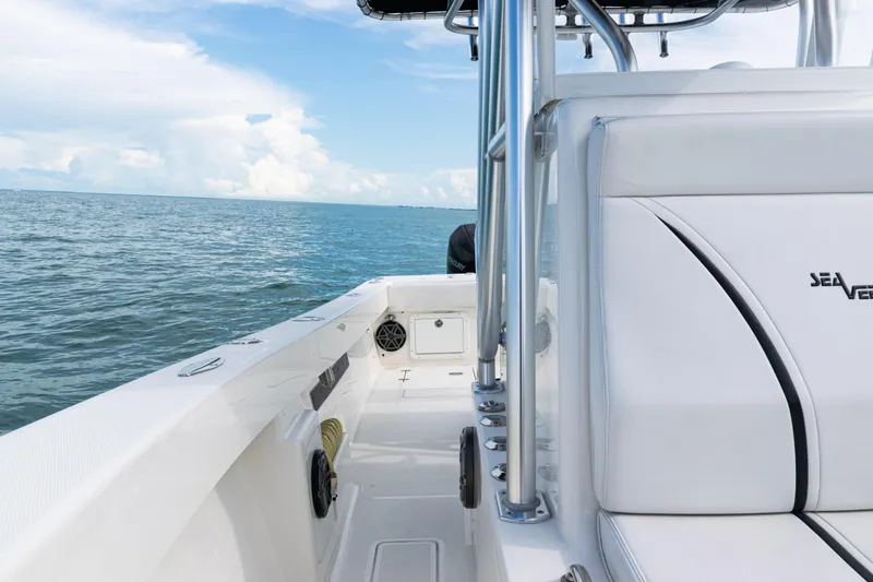 Slide: The Image of 2018 SeaVee 29 boat on open water, featuring sleek white seating and clear blue skies. - 18