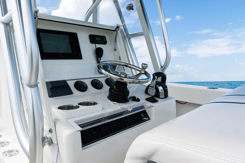 Slide: The Image of 2018 SeaVee 29 boat helm with steering wheel and navigation equipment. - 21