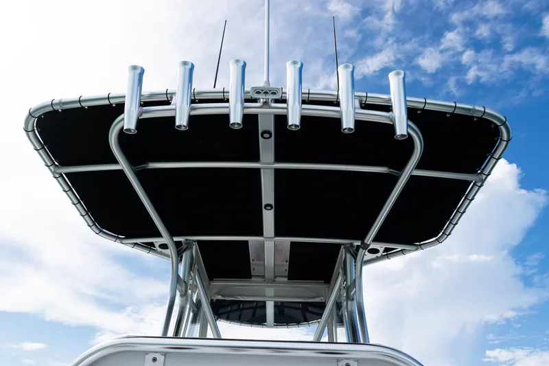Slide: The Image of 2018 SeaVee 29 boat with T-top and rod holders against blue sky. - 26