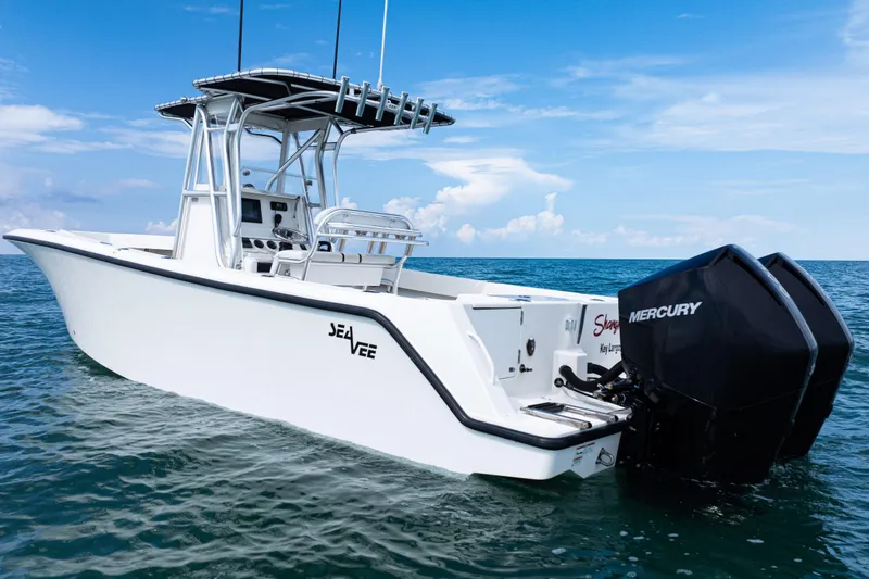 Slide: The Image of 2018 SeaVee 29 boat with dual Mercury engines on open water under blue sky. - 39