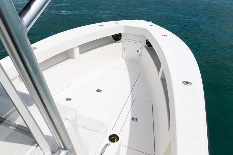 Slide: The Image of 2018 SeaVee 29 boat deck with storage compartments, on calm blue water. - 51