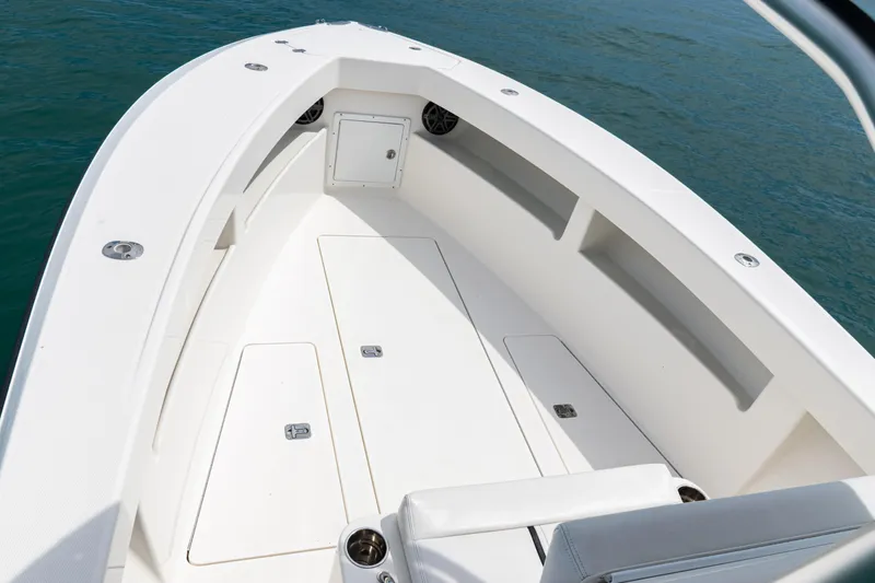 Slide: The Image of 2018 SeaVee 29 boat deck with storage compartments, surrounded by blue water. - 52
