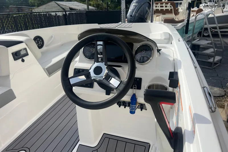 Slide: The Image of 2022 Hurricane SunDeck Sport 185 OB boat interior with steering wheel and controls. - 6
