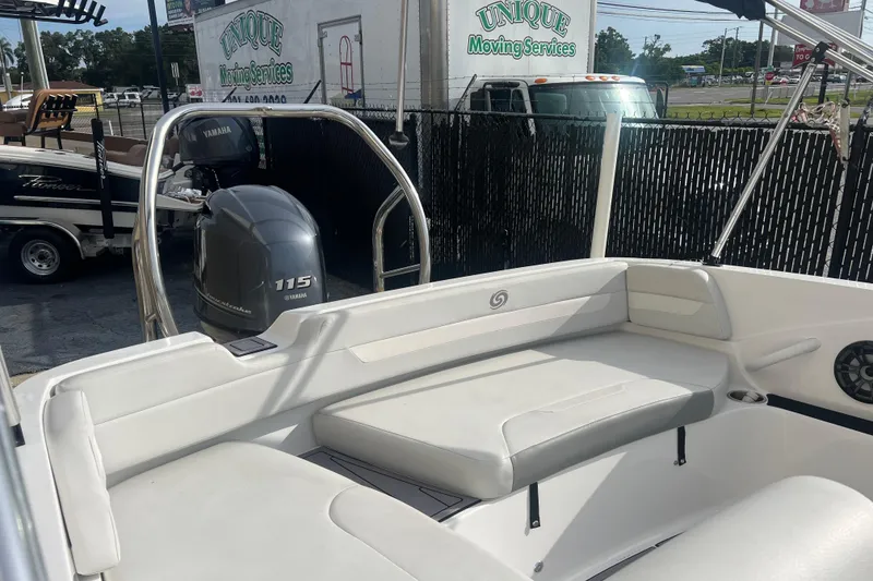 Slide: The Image of 2022 Hurricane SunDeck Sport 185 OB boat with Yamaha 115 engine, parked outdoors. - 7