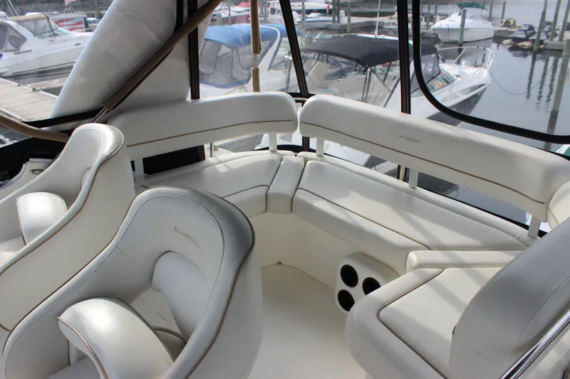 Slide: The Image of 2007 Silverton 36 Convertible boat interior with white leather seating and marina view. - 11