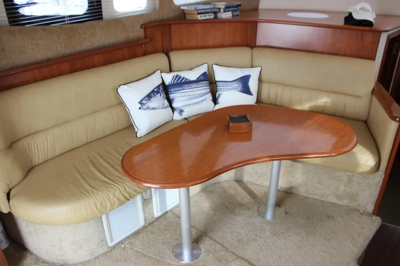 Slide: The Image of Interior of 2007 Silverton 36 Convertible with beige seating and fish-themed pillows. - 17