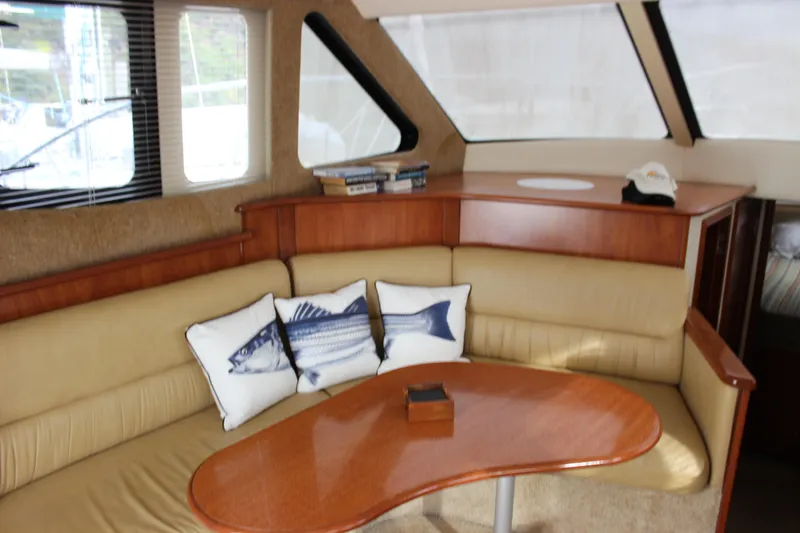 Slide: The Image of Interior of 2007 Silverton 36 Convertible yacht with cozy seating and nautical decor. - 18