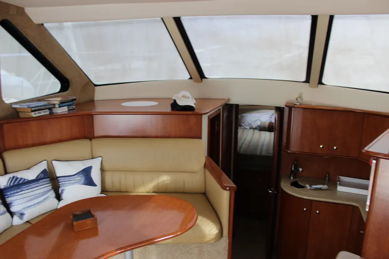 Slide: The Image of Interior of 2007 Silverton 36 Convertible yacht with cozy seating and wooden cabinetry. - 19