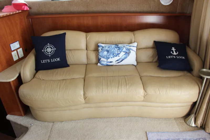 Slide: The Image of Beige leather sofa with nautical-themed pillows in a 2007 Silverton 36 Convertible yacht. - 21