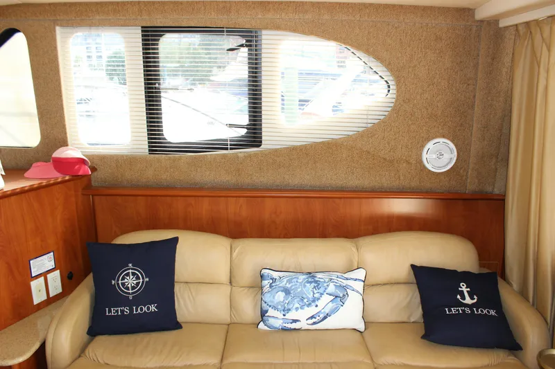 Slide: The Image of Interior of 2007 Silverton 36 Convertible yacht with beige sofa and nautical pillows. - 22