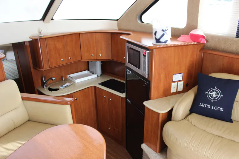 Slide: The Image of Interior of 2007 Silverton 36 Convertible yacht with kitchenette and seating area. - 23