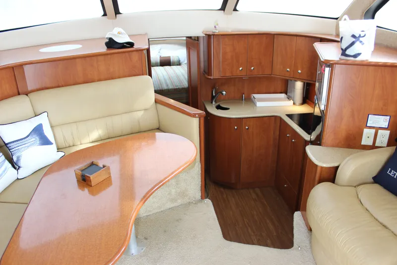 Slide: The Image of Interior of 2007 Silverton 36 Convertible yacht with elegant wood cabinetry and cozy seating area. - 24