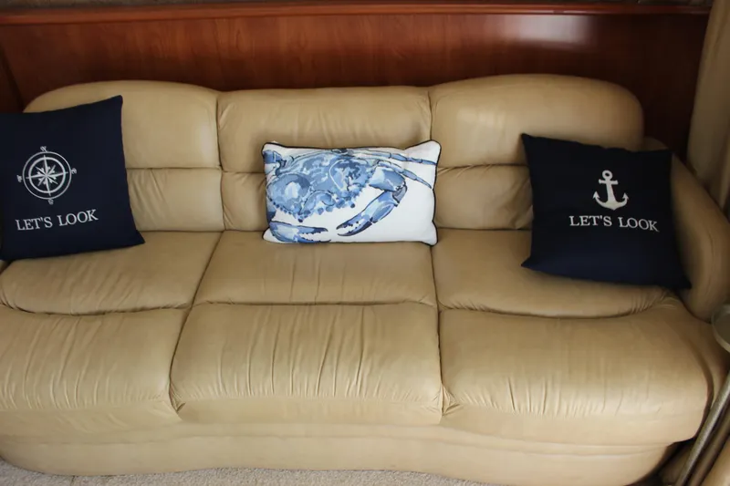 Slide: The Image of Beige leather sofa with nautical-themed pillows on a 2007 Silverton 36 Convertible. - 26