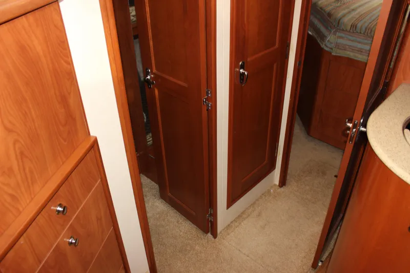 Slide: The Image of Interior of 2007 Silverton 36 Convertible yacht with wooden cabinetry and carpeted flooring. - 29
