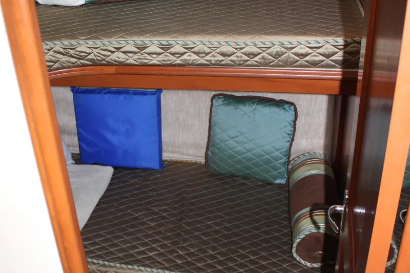 Slide: The Image of Interior of 2007 Silverton 36 Convertible with bunk beds and colorful cushions. - 32