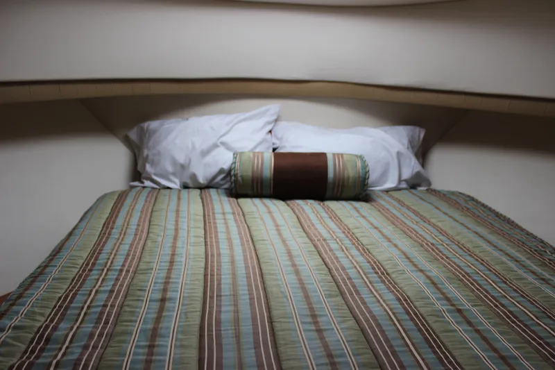 Slide: The Image of Cozy cabin bed in 2007 Silverton 36 Convertible yacht with striped bedding. - 35