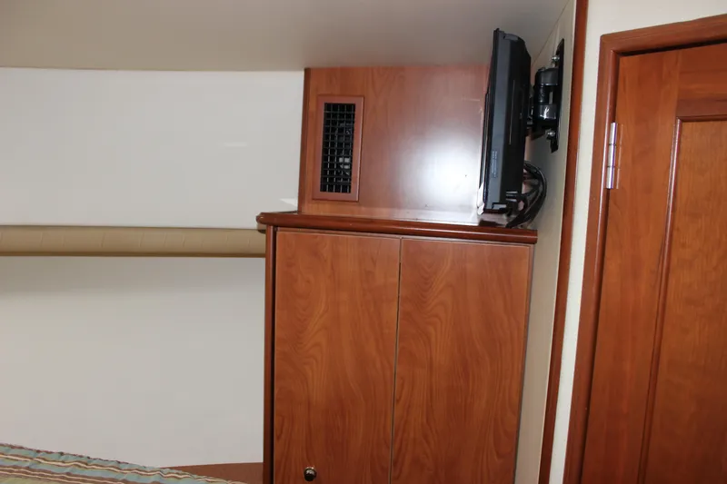 Slide: The Image of Interior of 2007 Silverton 36 Convertible yacht with wooden cabinetry and mounted TV. - 36