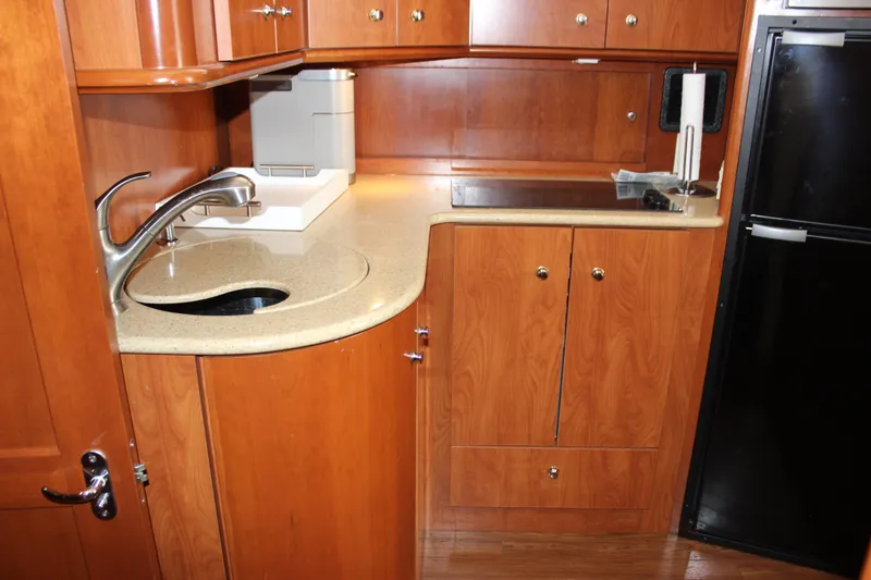 Slide: The Image of 2007 Silverton 36 Convertible yacht kitchen with wood cabinetry and modern appliances. - 40