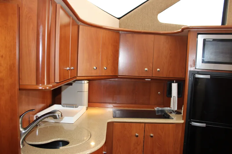 Slide: The Image of Luxurious 2007 Silverton 36 Convertible yacht kitchen with wood cabinets and modern appliances. - 42