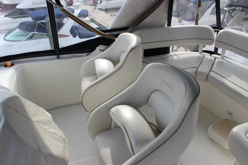 Slide: The Image of Interior of 2007 Silverton 36 Convertible yacht with luxurious white seating. - 7