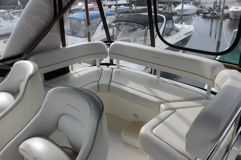 Slide: The Image of Luxurious interior of 2007 Silverton 36 Convertible yacht with white seating. - 8