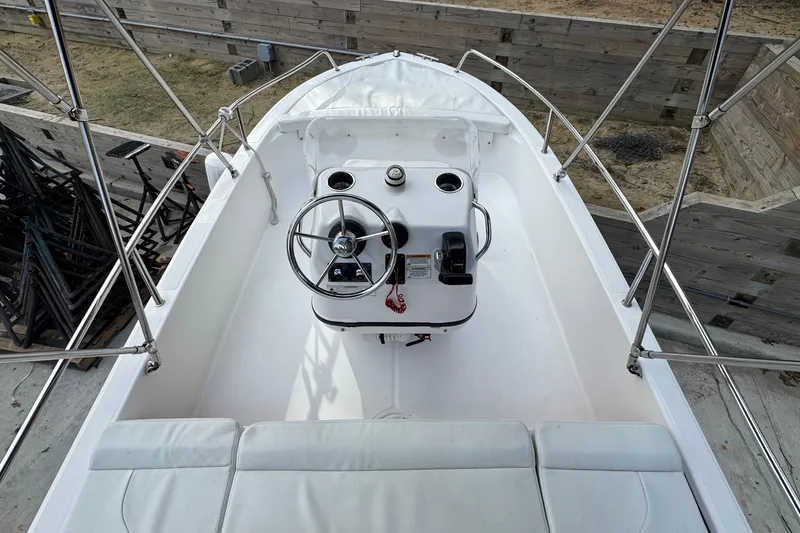 Slide: The Image of 2016 Edgewater 158CS boat interior with steering wheel and seating. - 10