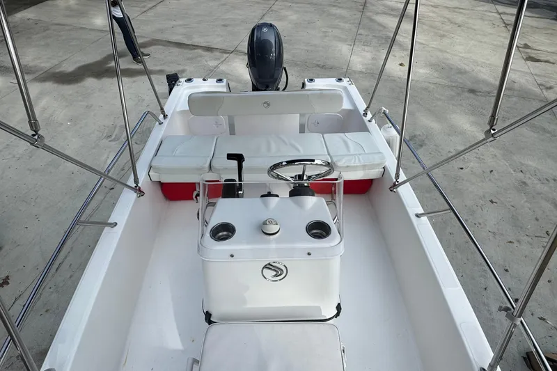Slide: The Image of 2016 Edgewater 158CS boat interior with steering console and seating. - 14