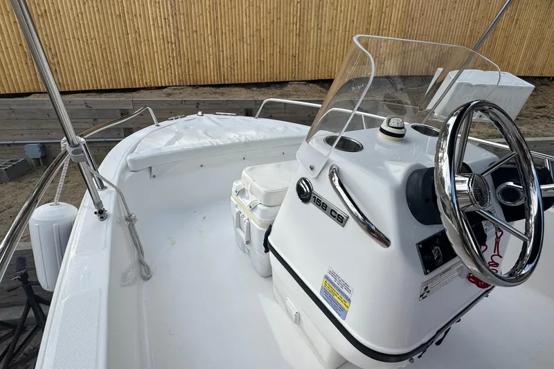 Slide: The Image of 2016 Edgewater 158CS boat interior with steering wheel and console. - 17
