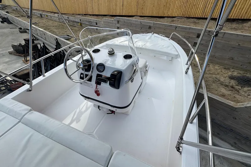 Slide: The Image of 2016 Edgewater 158CS boat interior with steering console and seating. - 19