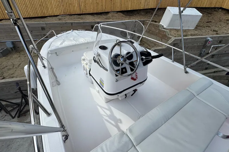 Slide: The Image of 2016 Edgewater 158CS boat interior with steering console and seating. - 20
