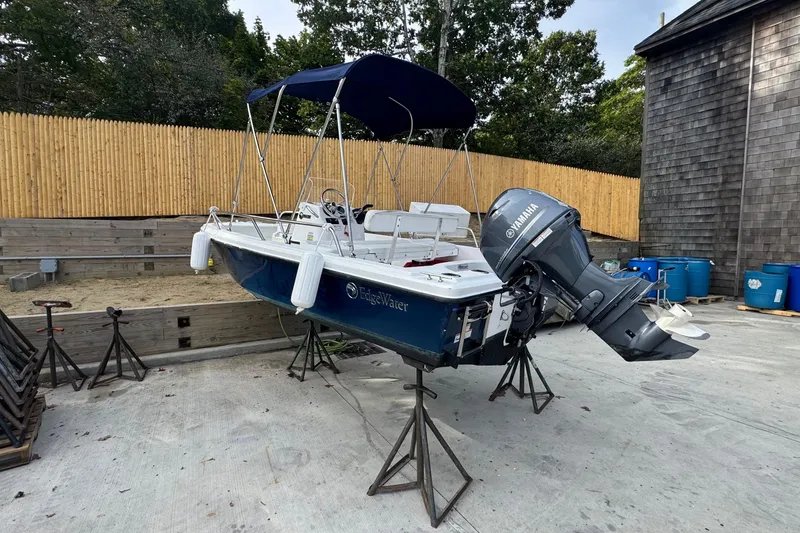 Slide: The Image of 2016 Edgewater 158CS boat with Yamaha outboard motor on stands, outdoor setting. - 4