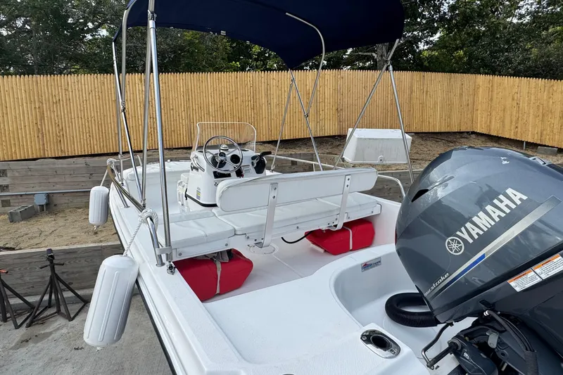 Slide: The Image of 2016 Edgewater 158CS boat with Yamaha engine, docked near wooden fence. - 5