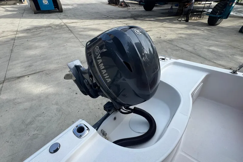 Slide: The Image of 2016 Edgewater 158CS boat with Yamaha outboard motor on a concrete surface. - 7